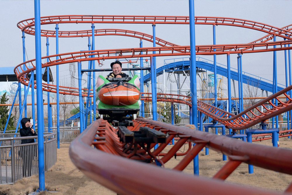 crazy mouse roller coaster running in a fairground