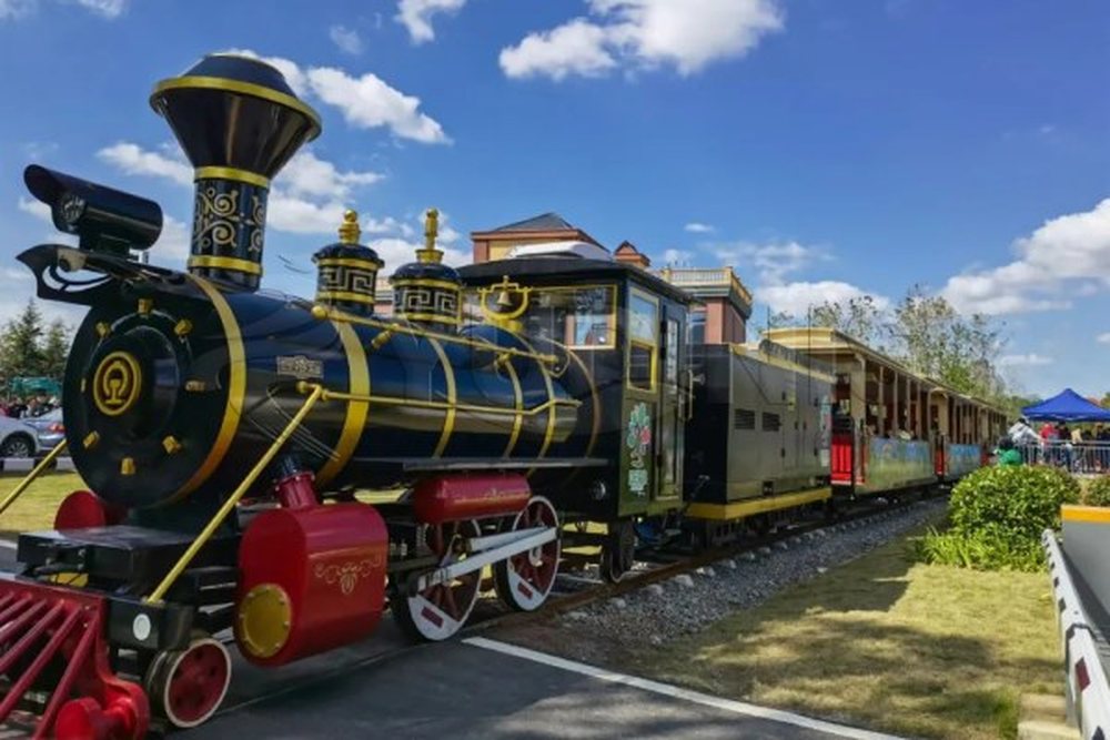 Diesel rail sightseeing train running through a resort park
